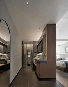 Modern minimalist bathroom with concrete walls and flooring, featuring sleek black fixtures and a large mirror.