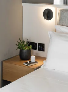 A modern bedroom showcasing textured materials and minimalist design elements.