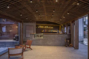 A modern cafe bar featuring stone, concrete, and wooden materials