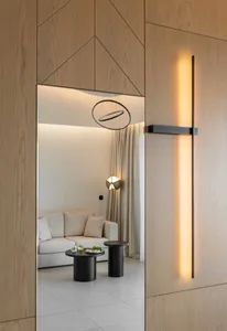 Modern living room with neutral-toned cushions, white curtains, and gray furniture.