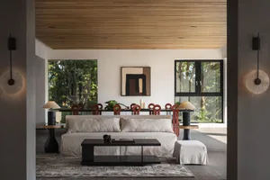 Modern living room featuring a white sofa, coffee table, and wood elements