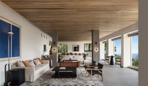 A modern living room with wooden accents and a white sofa.