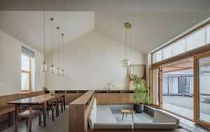 A modern living room with wooden furniture and a large window.