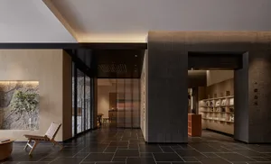 A modern office interior featuring concrete and wood materials.