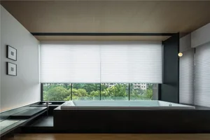 Modern bathroom featuring a large soaking tub with white blinds and a view of greenery.