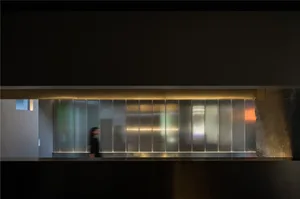 A modern interior space featuring a glass partition screen.