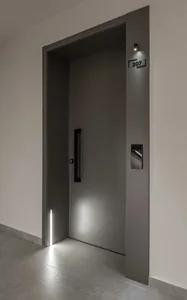 Modern interior with a metal door entrance, featuring sleek design and minimalist aesthetics.