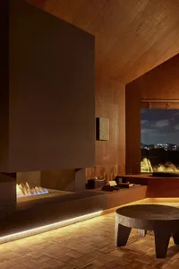Contemporary living room featuring wooden bench and wall-mounted light fixture