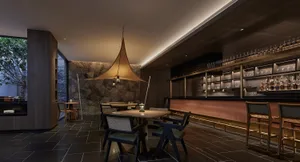 A modern restaurant bar with mixed materials and contemporary design.