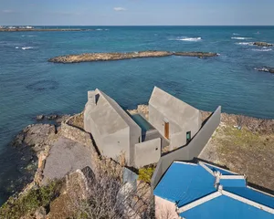 Modern vacation home designed in concrete, with a pool overlooking the ocean.