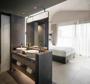 Modern bathroom with concrete and wooden elements, featuring a double sink vanity and a large mirror.