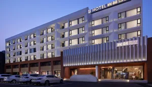A modern hotel building with glass and concrete facade.