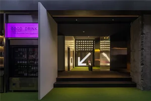 Modern retail entryway featuring a concrete, glass, and wooden design