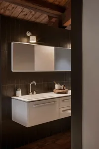 Industrial-style bathroom with metal sink, concrete tiles, and modern fixtures.