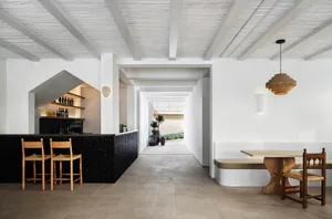 A minimalist restaurant interior featuring contemporary design elements such as wood and concrete materials.