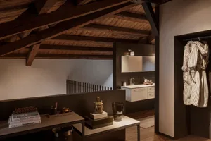 A modern bathroom with a wooden ceiling and a white sink.