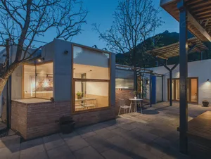 A modern outdoor space featuring brick walls and large windows.