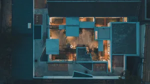 A modern residential building with concrete and wooden elements.