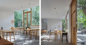 A modern restaurant interior featuring wood and glass materials.