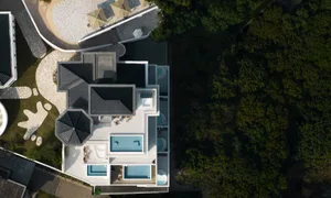 Modern villa with concrete floors and minimalist design.