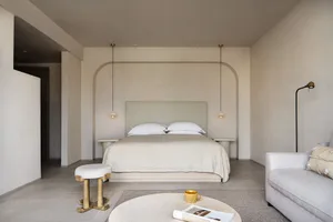A minimalist bedroom with neutral tones and a cozy, modern feel.