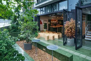 Modern cafe bar with wooden seating and concrete and glass surfaces