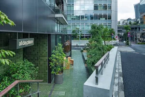 Modern office space interior with glass windows and greenery.
