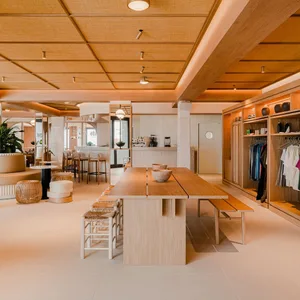 A cozy, minimalist coffee shop with wooden elements and a welcoming atmosphere.