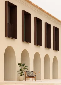 Modern building facade with arches, minimalist design, sandstone material
