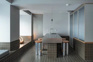 Modern residential kitchen featuring concrete countertops, tiles, and flooring.