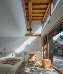 Modern minimalist bedroom featuring wood, concrete, and glass materials.