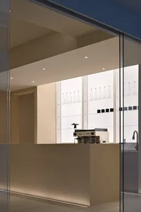 Modern minimalist coffee shop counter featuring transparent glass