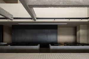 Modern industrial restaurant interior with concrete walls and seating