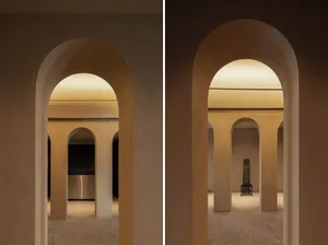 A modern interior space featuring a yellow lamp and arches.
