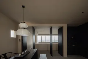 A modern residential interior with concrete walls, wooden accents, and large windows.