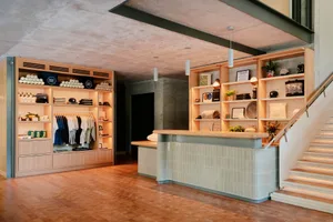 Industrial retail storefront with concrete walls and wooden shelves