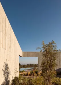 Concrete exterior of a modern house with a clear blue sky in the background.