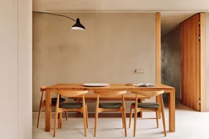 Modern dining room featuring minimalist furniture and wooden materials.