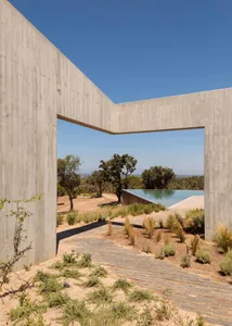 Modern outdoor space with concrete walls and a large pool.