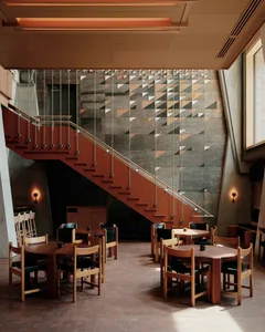 Modern, industrial restaurant interior with metal, concrete, and wooden textures.