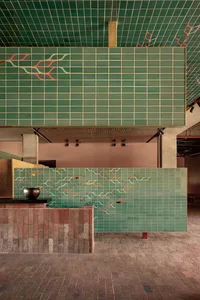 Modern interior space featuring green ceramic tiles with abstract patterns