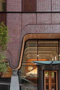 A modern lobby featuring glass walls and concrete architectural elements.