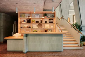 A retail shop interior featuring wood, concrete, and tile materials.