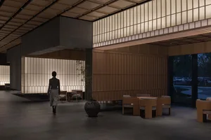 現代極簡大廳，混凝土牆面鑲嵌玻璃磚，並搭配木質家具。