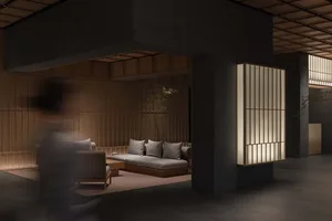 Contemporary living room with concrete walls, wooden furniture, and minimalistic design.