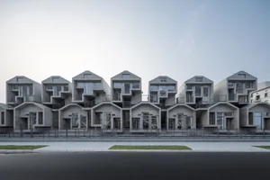 Multiple-storied, modern, concrete residential buildings with large windows.