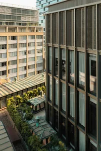 Façade of a building featuring a modern design with metal, glass, and concrete materials.