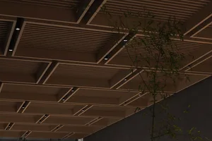 Industrial-style ceiling design featuring wooden panels and metallic accents.