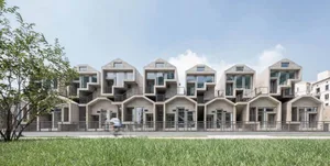 Modern buildings with concrete exteriors and geometric shapes.
