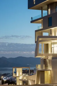 A modern building with a concrete exterior featuring intricate architectural design.